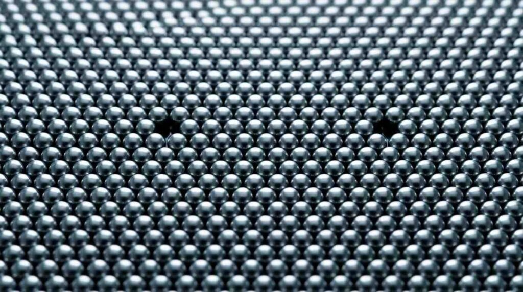 Polished steel spheres in a triangular lattice with a few missing