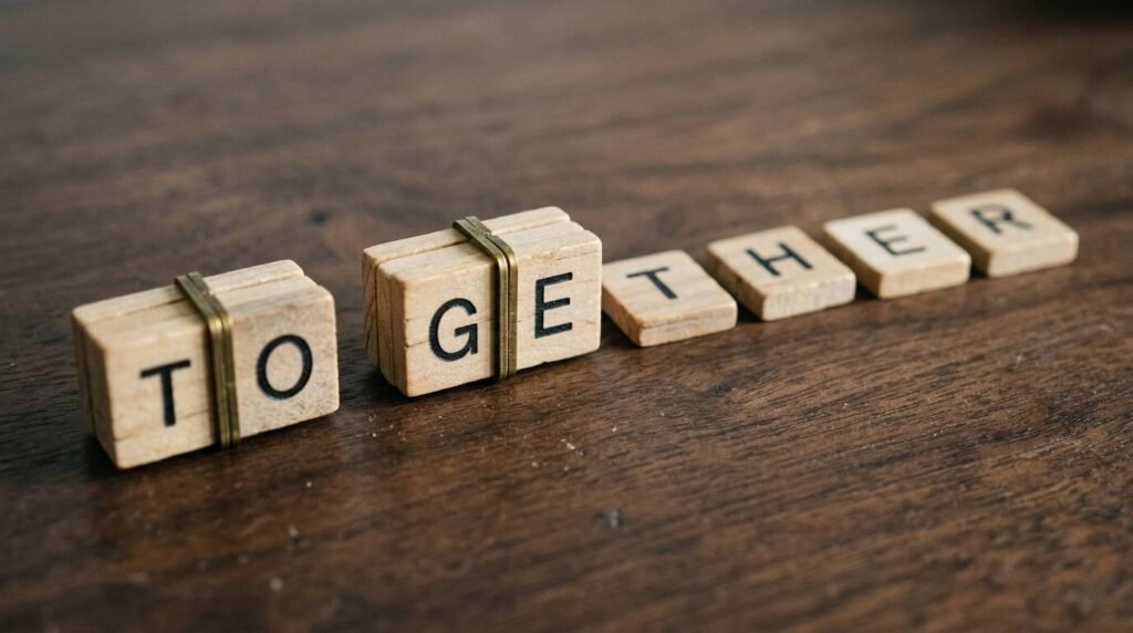 Wooden letter tiles spelling a word, half bundled into chunks and half separated.