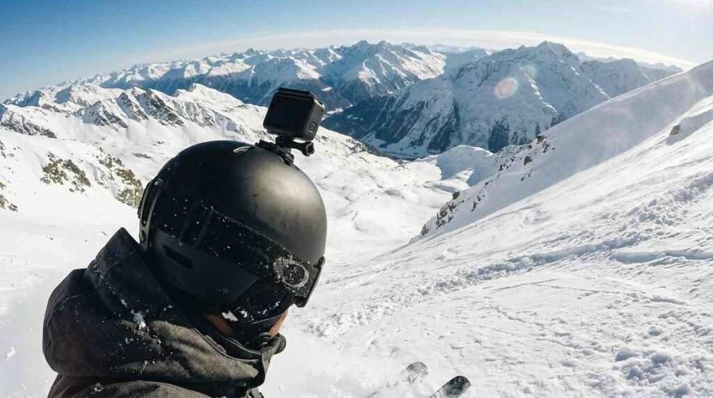 Action camera on a ski helmet over a snowy slope